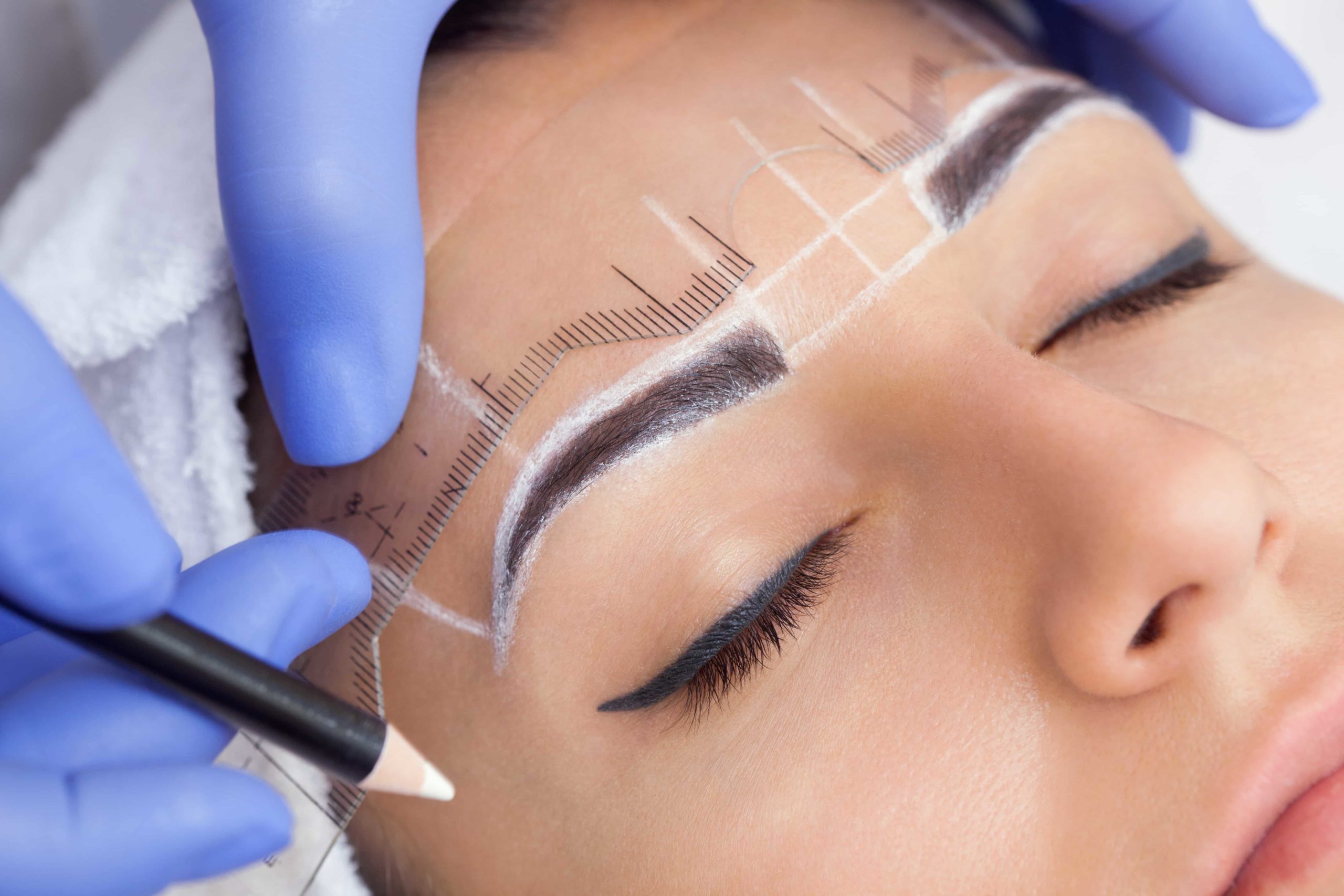 Eyebrows microblading concept. Cosmetologist preparing young woman for eyebrow permanent makeup procedure | Ella Esthetics in Alexandria, VA