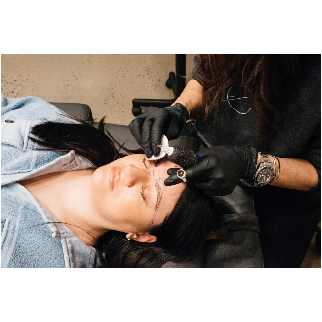 Eyebrows microblading concept. Cosmetologist preparing young woman for eyebrow permanent makeup procedure and Clinic with beauty products in a Spa | Ella Esthetics in Alexandria, VA
